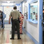 Medical Release Denied—Then He’s Gone Corrections officers escort an inmate in a jail hallway