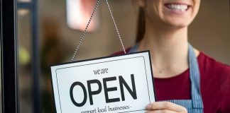 Salon Showdown Caught On Camera Shop worker holding an open sign