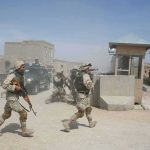Survivor Testimony Rattles Pentagon Line Soldiers in desert uniforms run past a checkpoint amid dust