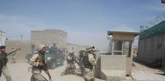 Survivor Testimony Rattles Pentagon Line Soldiers in desert uniforms run past a checkpoint amid dust