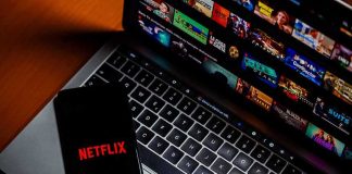 Band Fights Netflix Over Stolen Name Smartphone with Netflix logo on a laptop keyboard