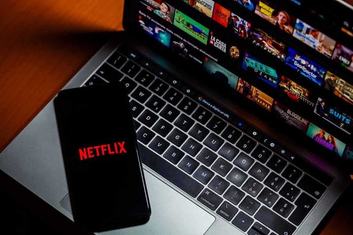 Smartphone with Netflix logo on a laptop keyboard