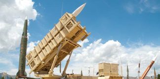Banned Range Returns — Guess Who Blinked Patriot missile defense system on display outdoors with various missiles in the background