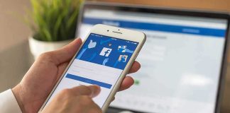 hands using a smartphone with a social media login screen
