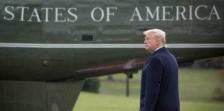 Judge SLAPS Down Military Voting Hurdle man walking beside a helicopter on a grassy field