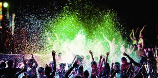 Beach Stroll Turns Venom Scare Crowd dancing in a pool under colorful lights