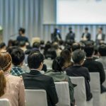 Bill Kenney at a conference panel with an audience