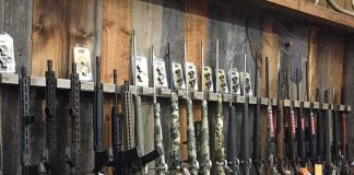 rack of rifles and shotguns in a gun store