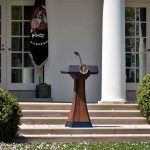 Medal Mystery Shadows White House Hero Podium with presidential seal in a garden colonnade