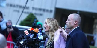 Woman addressing a press conference with multiple microphones