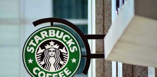 Starbucks’ 1% Cut Hides a Bigger Play Starbucks coffee shop sign on building exterior
