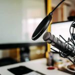 Four-Word Jab Sparks Tribal Meltdown Podcast microphone with pop filter on desk