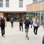 Confidentiality vs. Parents: High-Stakes NJ Fight Students with backpacks walking toward a school entrance
