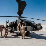 A U.S. Attack Helicopter Went Down Near Iran—What Really Happened? Soldiers inspect a military attack helicopter on a tarmac