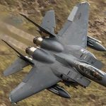 Alien-Like Drones, Downed Jet — Where’s The Proof? Fighter jet banking low over rugged terrain