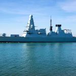 North Korea’s Warship Stunt—What’s Not Adding Up naval destroyer sailing in calm harbor waters