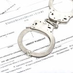 Zero Delay After Conviction — Why That Should Be the Law Handcuffs on arrest warrant documents