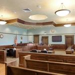 Abuse Accuser Takes Fight Beyond Family Court Empty courtroom with wooden benches and judge's bench