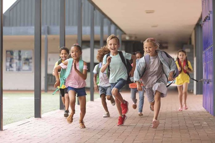 shutterstock_1352249762 Group of schoolchildren running down a hallway