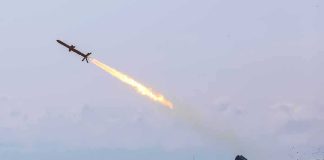 Cruise missile launches from mobile launcher in open field