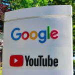 Google Dodges Axe, Keeps The Stack Google and YouTube logos on an outdoor office sign
