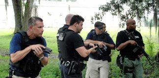 law enforcement officers conducting a search in a wooded area