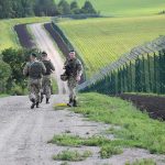 Border Standoff Escalates — Troops Stay Put Soldiers patrolling along a rural border fence