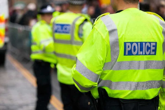Police officers in high-visibility jackets standing on a street