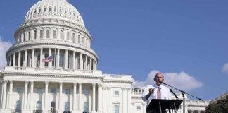 Louie Gohmert speaking at a podium outside the U.S. Capitol