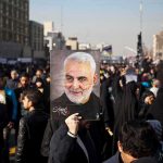 Press Visa, Pro‑Regime Vibes? Critics Pounce Qasem Soleimani portrait held aloft in a crowded street gathering