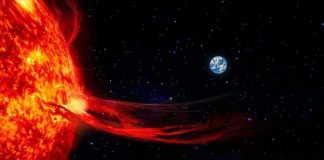 Sun with solar flare extending toward Earth in space