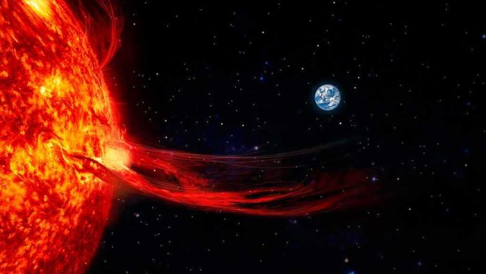 Sun with solar flare extending toward Earth in space