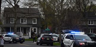 Passing Cars Suddenly Come Under Arrow Fire Police SUVs with lights on block a suburban street