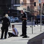Brooklyn Grab Attempt Shocks McDonald’s Crowd Police officers detain a seated man on a city sidewalk
