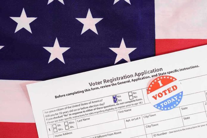 shutterstock_1784113625 Voter registration form with I Voted sticker on American flag