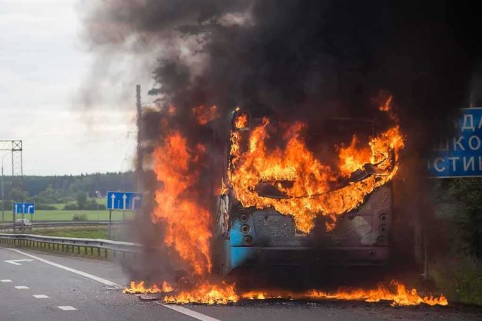 shutterstock_1797604411 burning bus on highway with heavy black smoke