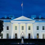 Iran’s Latest Trump Threat Gets Personal White House illuminated at dusk with flagpole and columns