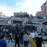 Fiesta Chaos — Mystery Blast Levels Church Walls Rescue workers and civilians on collapsed building after earthquake