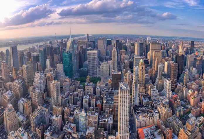 shutterstock_1922605346 Aerial view of a dense city skyline at sunset