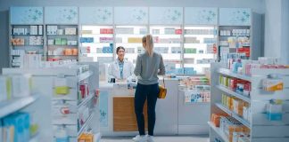 Yvonne Li assisting a customer at a pharmacy counter