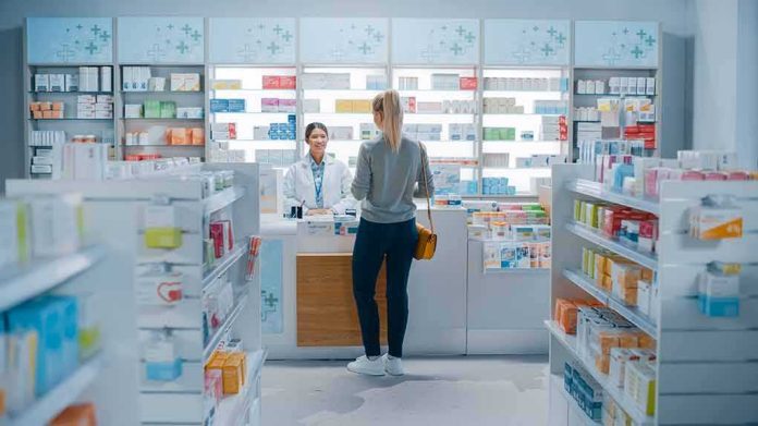 Yvonne Li assisting a customer at a pharmacy counter