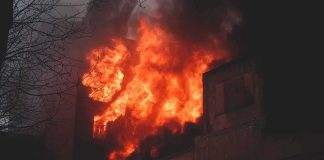 Building engulfed in flames at night