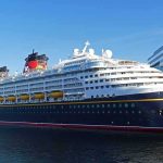Cruise ship docked at a modern harbor terminal