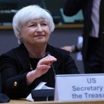 January Showdown: Markets Hold Breath older woman at conference table with nameplate and microphone