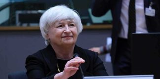 January Showdown: Markets Hold Breath older woman at conference table with nameplate and microphone