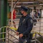 Police Release Images After Harlem Subway Rape Police officer stands in a subway station near caution tape
