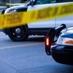 Austin On Edge: DPS Defers, Footage Withheld Police cars behind yellow caution tape at a street scene