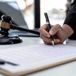 60 Minutes Showdown: Grief Vs. Conspiracies Hand signing legal document beside gavel and laptop