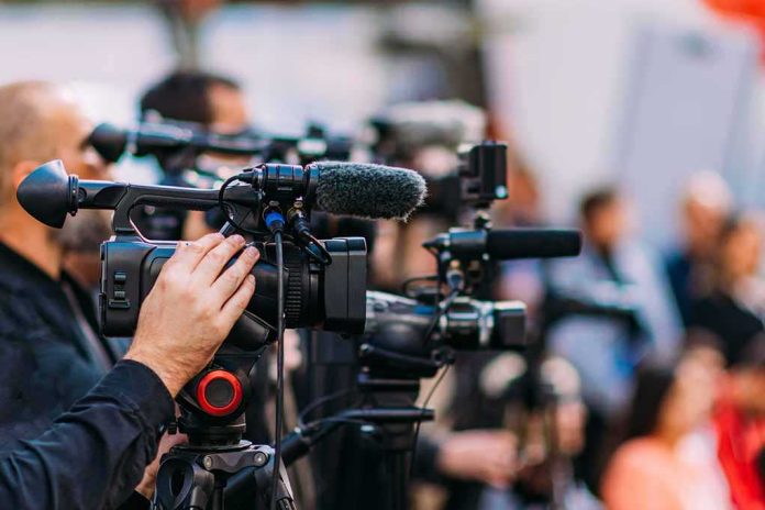 shutterstock_2233193507-3 Video cameras on tripods at a media event