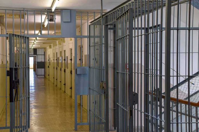 shutterstock_2284784009-1 Prison corridor with barred doors